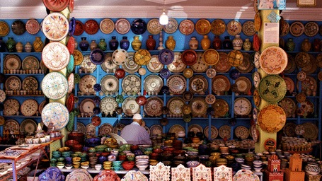 A close up of a craft shop with many items placed strategically to be sold to visitors.