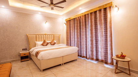 A classic luxury bedroom with a large bed, heavy curtains, and clean minimalist decor - Golden Oak By The Lake Hill, Khurpatal