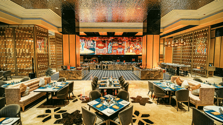 A close-up shot of the restaurant with beautifully arranged tables, showcasing its stylish ambience - Grand Madurai by GRT Hotels