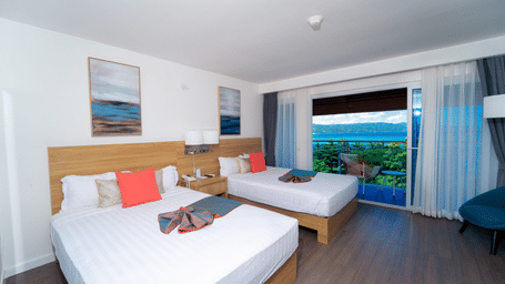 A view of a hotel room at Hotel 39, Jamaica (Montego Bay), with a balcony that offers the view of the shore.