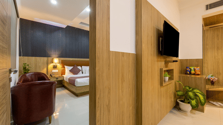 Interconnected Family Room under warm lighting at Hotel Corporate Suites featuring a wall separating the 2 bedrooms