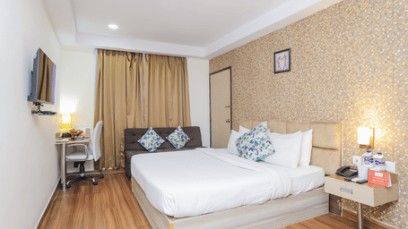 Another perspective of a hotel room featuring a double bed and simple elegant decor - Hyphen Grand, Haridwar
