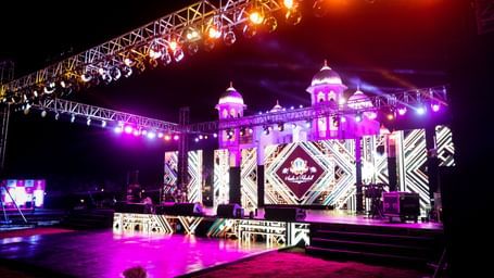 A view of the stage illuminated with neon lights featuring a digital screen - Kaldan Samudhra Palace