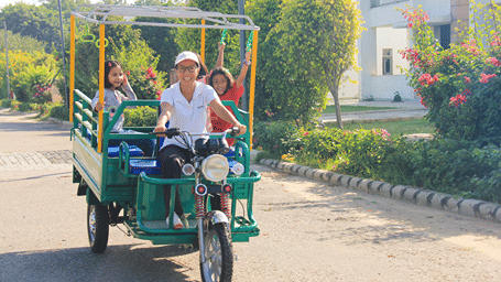 A group of people enjoying a leisure ride in an rickshaw - Karma Lakelands.