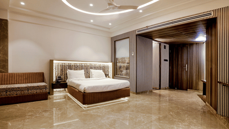 A room with spacious interiors and comfortable bedding at Kumar Resort by Turtle.