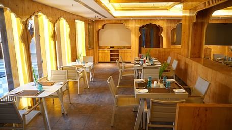 a wooden themed restaurant seating arrangements at Lords Hrim Resort Basar 