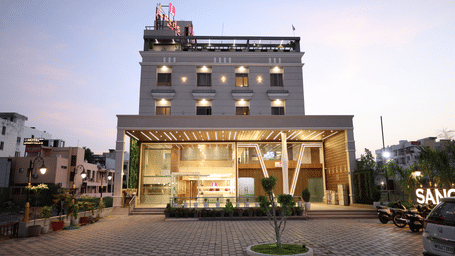 The illuminated facade of Lords Inn Sangam, Bhopal a modern multi-storey hotel.