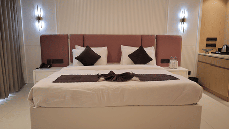 Spacious bedroom at Verdant Plunge Villa with king-size bed, warm lighting, and modern interiors.