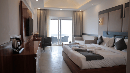 Elegant Forest Edge Room featuring king bed, modern interiors, and balcony access.