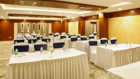 A conference hall at the Nemesia City Center with the tables and chairs set in a theatre style setup.