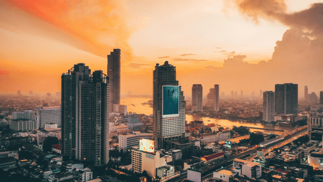 Bangkok City skyline with sunset over the River of Kings in the Silom area.