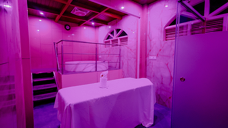 A room with a white bathtub and purple lighting at Nirantara Resort & Spa.