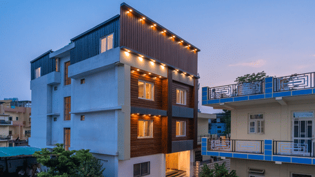 facade of Perfectstayz premium aiims during evening.