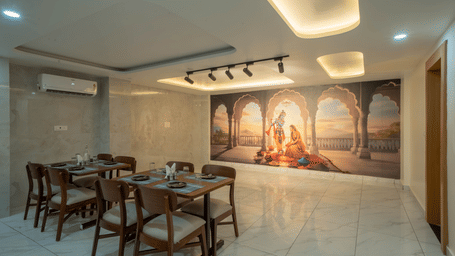  Elegant restaurant dining area with Krishna mural and ambient lighting at Perfectstayz Premium Krishna Abode, Vrindavan