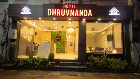 Exterior of Perfectstayz Value Dhruv Nanda featuring the entrace of the hotel during the night.