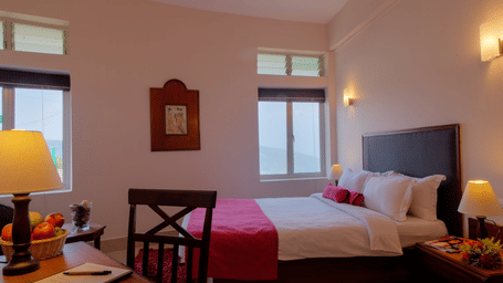 room with soft lighting, armchair, and well-appointed desk setup - Polo Cherrapunjee Resort