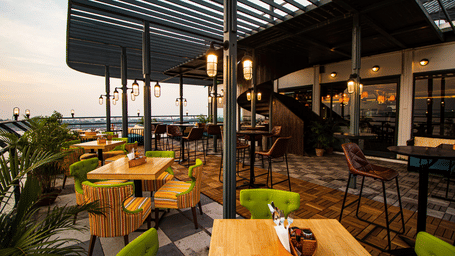 The seated dining deck of the Polo Floatel during daytime.