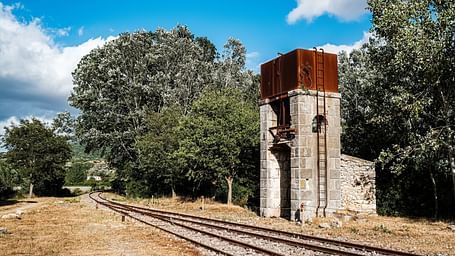 image of railway tracks with a bright backdrop of ble sky