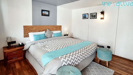 image of the deluxe room featuring a plus double bed with ample of natural light - The Tattva Boutique Resort