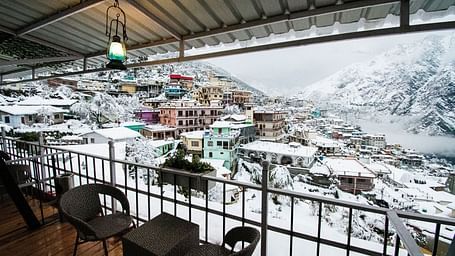 image of the city views on a snowy day with a think blanket of white snow covering everything - The Tattva, Joshimath