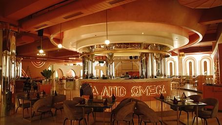An image of a restaurant featuring a counter, and tables and chairs set at Themis Barbecue House, Ambala