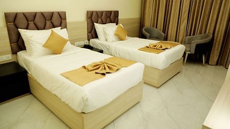 Twin bed deluxe room at Town Square Suites featuring elegant furnishings and cozy ambiance