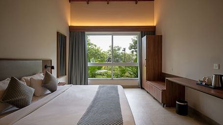 Spacious bedroom at Ananta Villa – 3-Bedroom Villa, Trance Veechika Resort, Vikarabad, with garden views and warm ambient lighting.