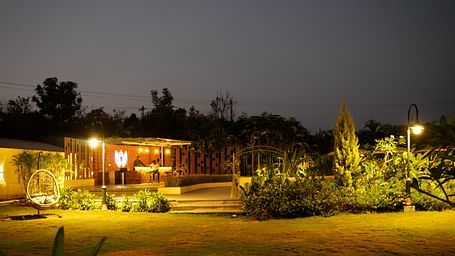 An image of the common area with bright lighting and greenery - Trance Veechika Resort