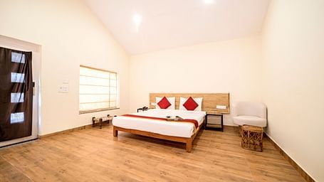 A room at Valley by Grassfield featuring a bed, a window on the side, and ceiling lights.