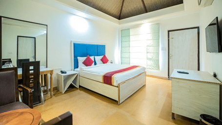 French Deluxe room with bed, window seat, and sofa at Valley by Grassfield, a resort in Jaipur.