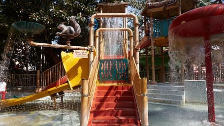 An overview of the Multi Lane ride at Water Kingdom with water falling down on other structures.