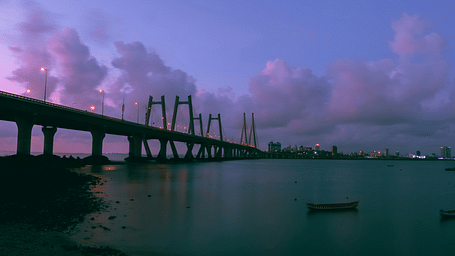 Shot of a bridge over the sea during sunset.