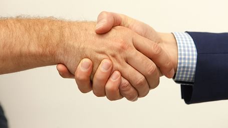 Two men indulging in a handshake