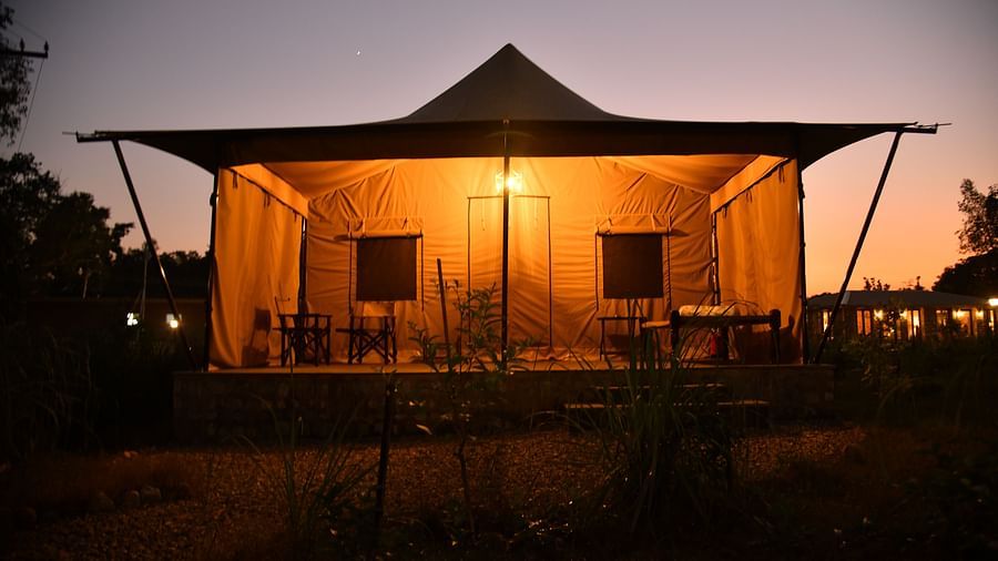 An image of a tent lit by a warm lamp - Aalia Jungle Resort & Spa