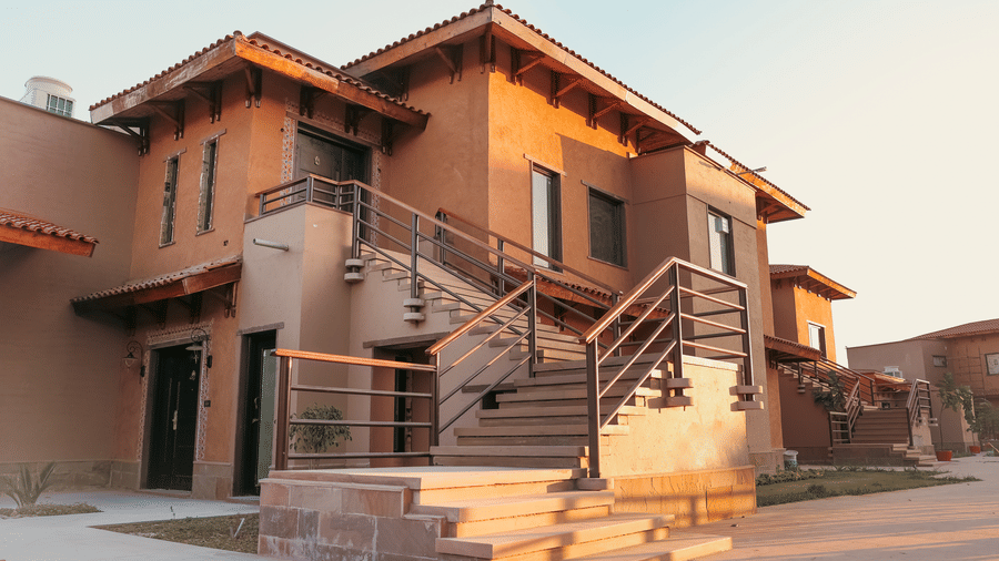 A resort building featuring an external staircase under a bright sky at Aamaghati Wildlife Resort.