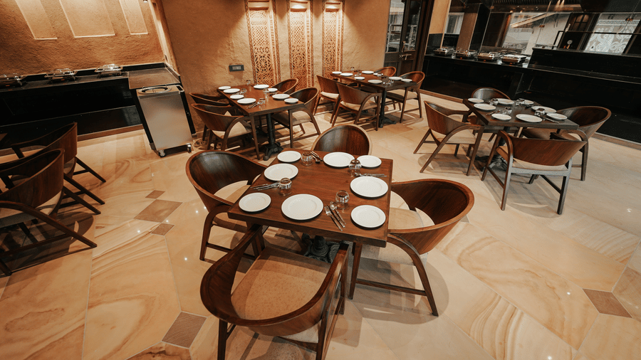  A beautifully appointed restaurant area with a patterned floor and many tables at Aamaghati Wildlife Resort.