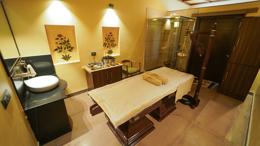  An inviting spa treatment room with soft lighting and a calming ambience at Aamaghati Wildlife Resort.
