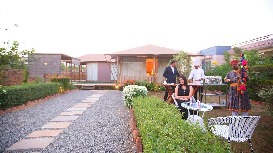 Front view of the Luxury Wooden Tent, with vibrant plants lining the pathway at Aanandam Resort & Spa