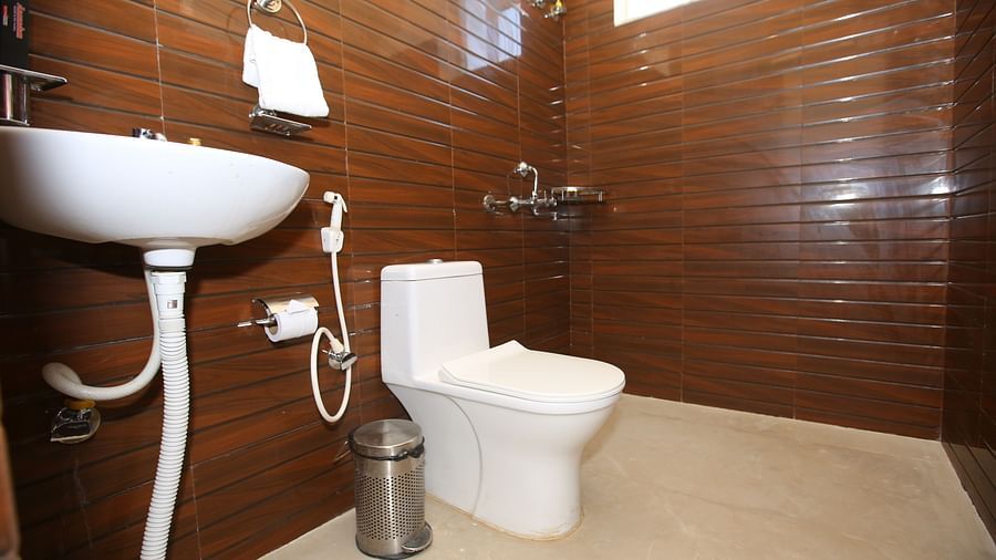 Studio Villa washroom featuring a sleek sink and convenient amenities, including a toilet paper holder, at Aanandam Resort & Spa