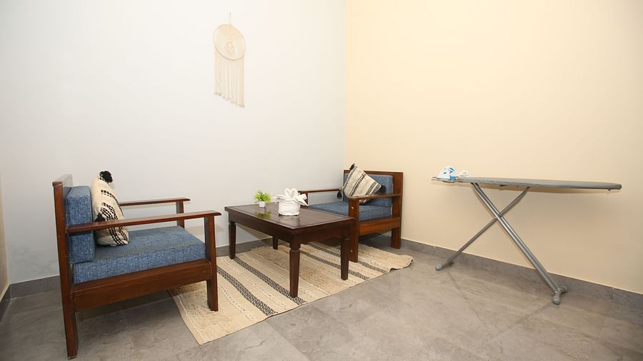Interior of the Studio Villa featuring a cosy corner with two chairs and a table at Aanandam Resort & Spa
