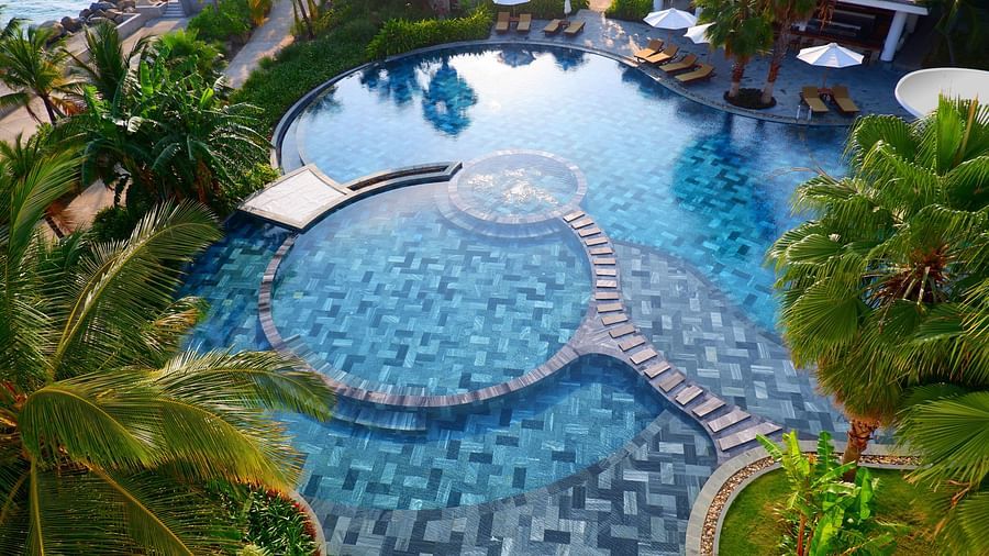 An aerial view of the resort showing pool, some villas, and palm trees - Alibu Resort Nha Thrang