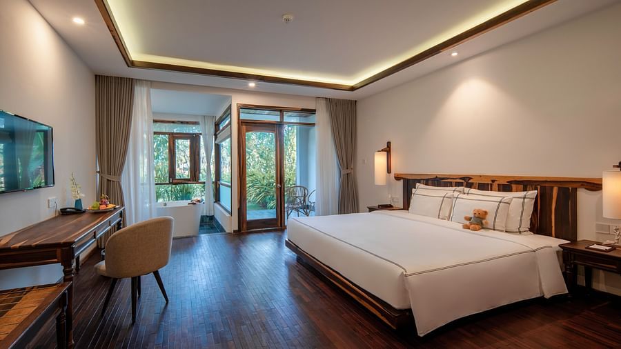 An image of a well furnished bedroom which has a flat TV screen - Alibu Resort Nha Thrang