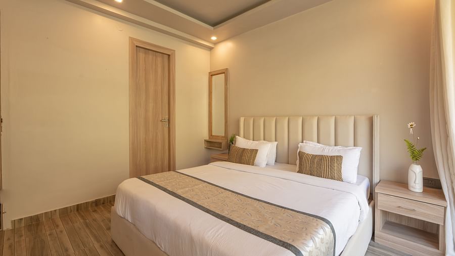 Room with double bed and soft lighting.