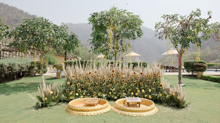 his image showcases a beautiful outdoor venue set against a picturesque backdrop of mountains and greenery. 