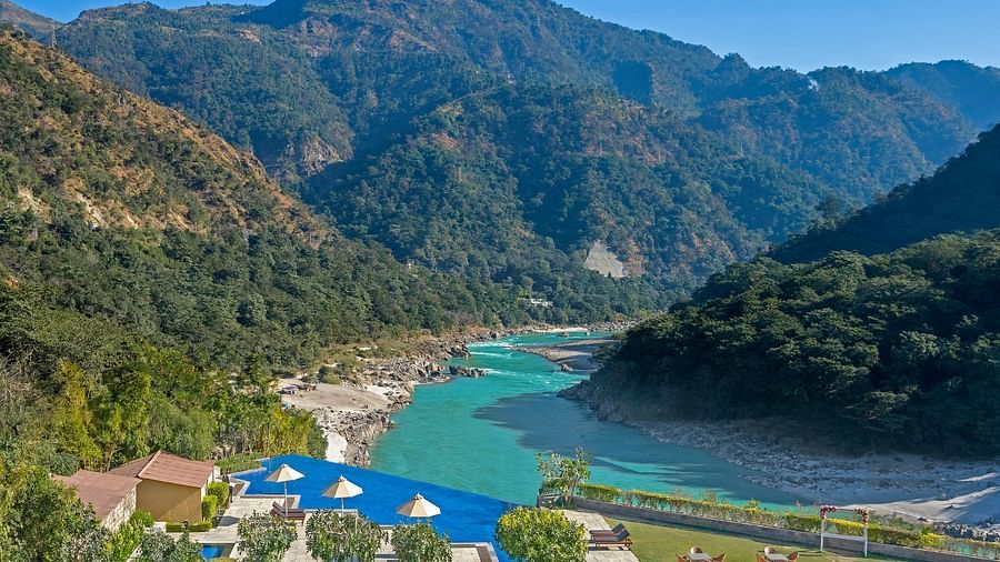 An image capturing a breathtaking landscape featuring a serene river winding through a mountainous valley.