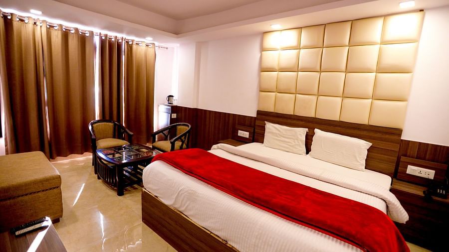 Image of a room with a bed and window on the side at Amara Hill Queen, Mussoorie.