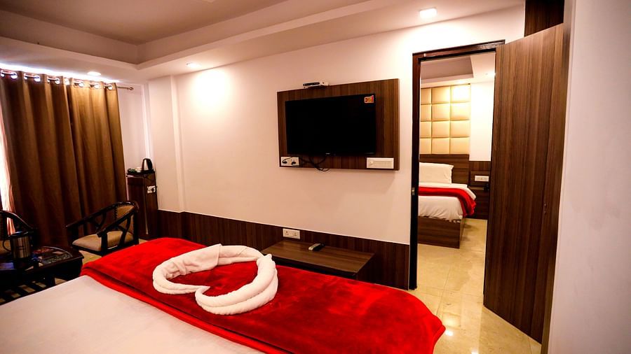 Image of a room with a bed and a television in front at Amara Hill Queen, Mussoorie.