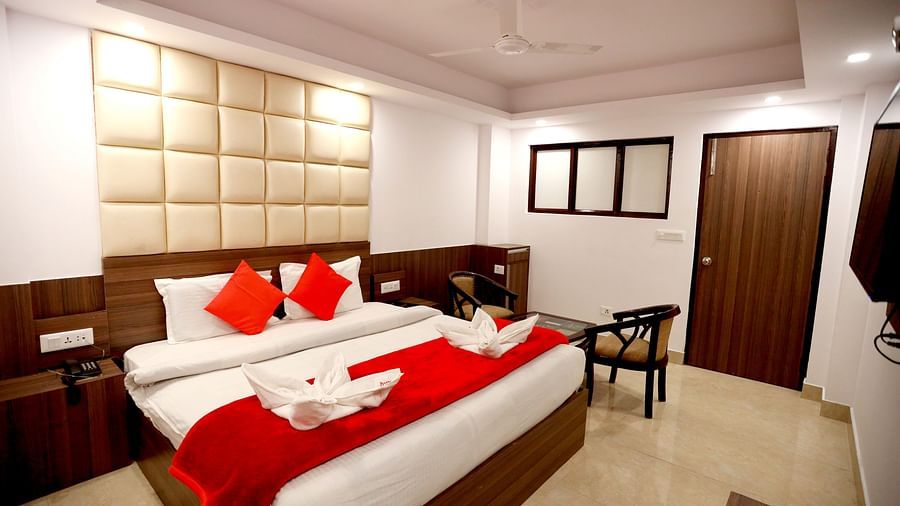 Image of a room with a bed and a seating area on the side at Amara Hill Queen, Mussoorie.