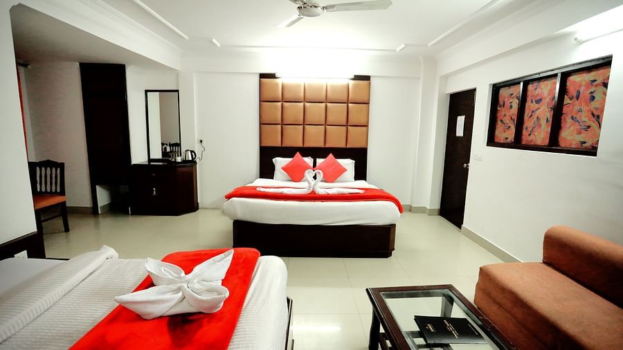 Image of a room with two beds and a sofa in the corner at Amara Hill Queen, Mussoorie 