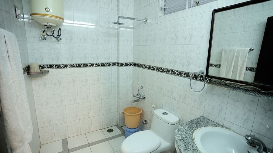 Image of a washroom with a sink and a toilet at Amara Hill Queen, Mussoorie.